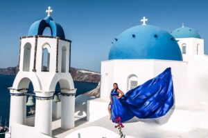 Exclusive Santorini Flying Dress Photoshoot with Pickup - Stop 1 in Imerovigli: blue domes, rooftops, and volcano views