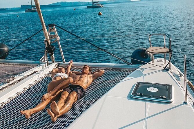 Half-Day Exclusive Catamaran Cruise in Santorini with Meal and Open Bar - Red Beach Swim Stop: Volcanic Color and a Quick Hit of Magic