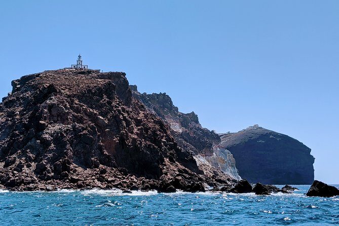 Private Full-Day Motor Yacht Cruise with Meal, Open Bar+Transfers - Through the caldera: caves, black formations, and Venetian Lighthouse views