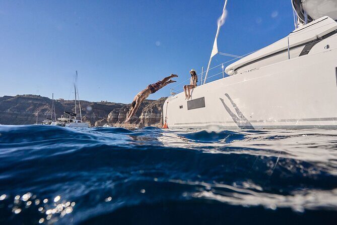 Santorini: Caldera Private Catamaran Cruise with Meal & Drinks - The south-coast sight breaks: lighthouse and volcanic scenery