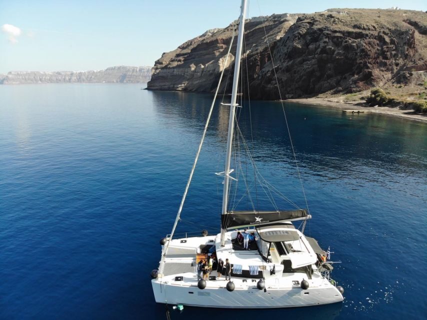 Santorini: Catamaran Cruise with Meal & Open Bar - Hot springs time at Santorini Volcano: warm water plus quick snorkeling