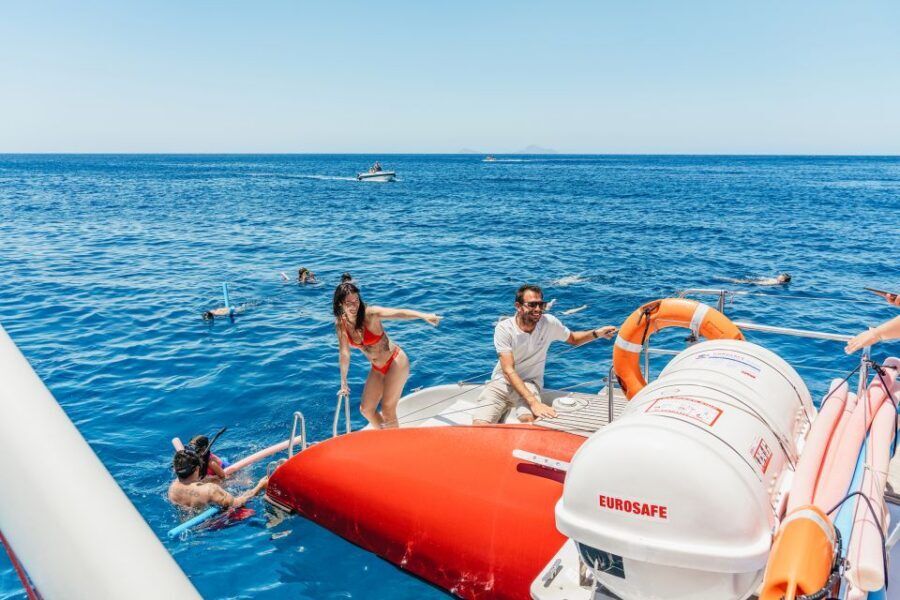 Santorini: Catamaran Tour with BBQ Dinner, Drinks, and Music - A 5-Hour Catamaran Loop: Hot Springs, Red Beach, White Beach, and Caldera Views