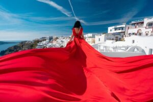 Santorini flying dress photo - Where You’ll Shoot: Oia or Imerovigli (The Choices Matter)