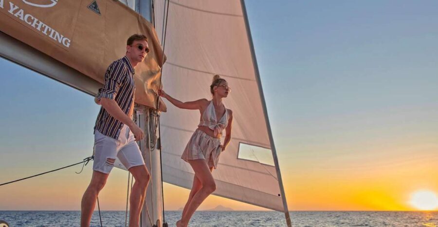 Santorini Gold Catamaran Cruise with Snorkel, BBQ & Open Bar - Red Beach cliffs to White Beach lighthouse views