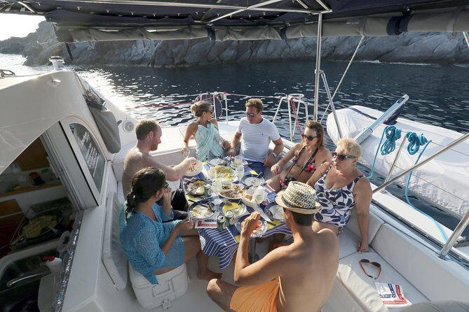 Santorini Half Day Catamaran Private Cruise incl. Meal, Drinks & Free Transport - White Beach: similar cliffs, calmer mood, and clearer water