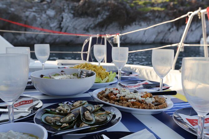 Santorini Half Day Catamaran Private Cruise incl. Meal, Drinks & Free Transport - Faros lighthouse: history in the corners of your camera roll