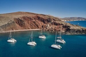 Santorini: Luxury Catamaran Cruise with Fresh Fish BBQ & Drinks - Red Beach and the changing colors between Red and White