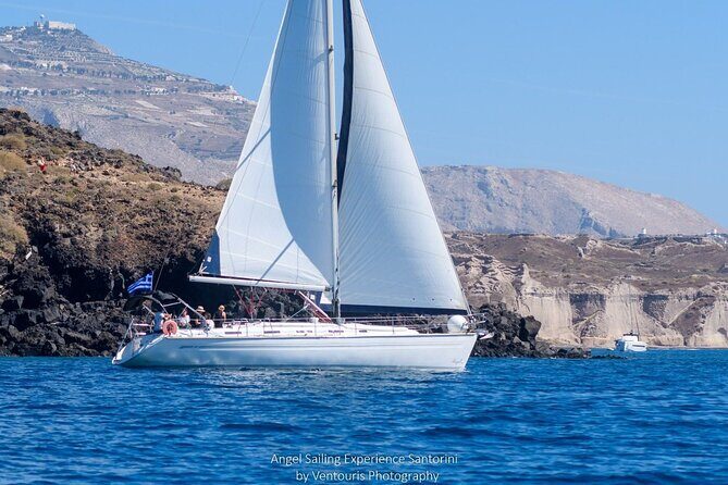 Santorini Private Daytime Sailing Tour with Meal, Drinks &Transfer included - Thirasia swimming in the caldera bay, plus a homemade lunch on board