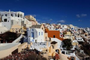 Santorini Private Romantic Tour with Dinner & Wine Tasting - Three Bells of Fira and the Blue Dome selfie with volcano backdrop