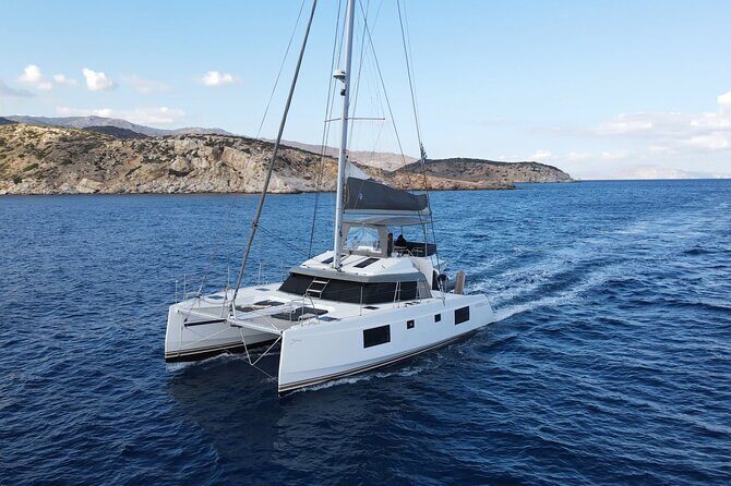 Santorini Private Tour Half-Day Sailing Platinum Catamaran Cruise - Red Beach’s iron cliffs: your first color hit from the water