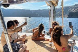 Santorini Sunset Sailing Cruise: Dinner, BBQ, Open Bar, Transfers - Stop 1 at Red Beach: swim, snorkel chances, and bold color photos