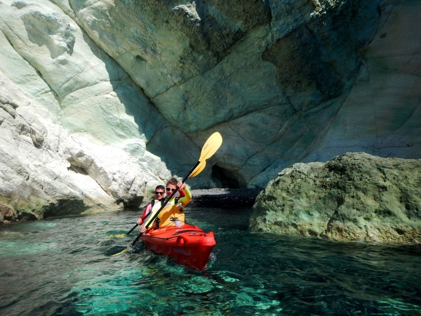 Santorini: Sunset Sea Kayak with Light Dinner - Rock Formations and Cave-Like Cliffs on the Westbound Return