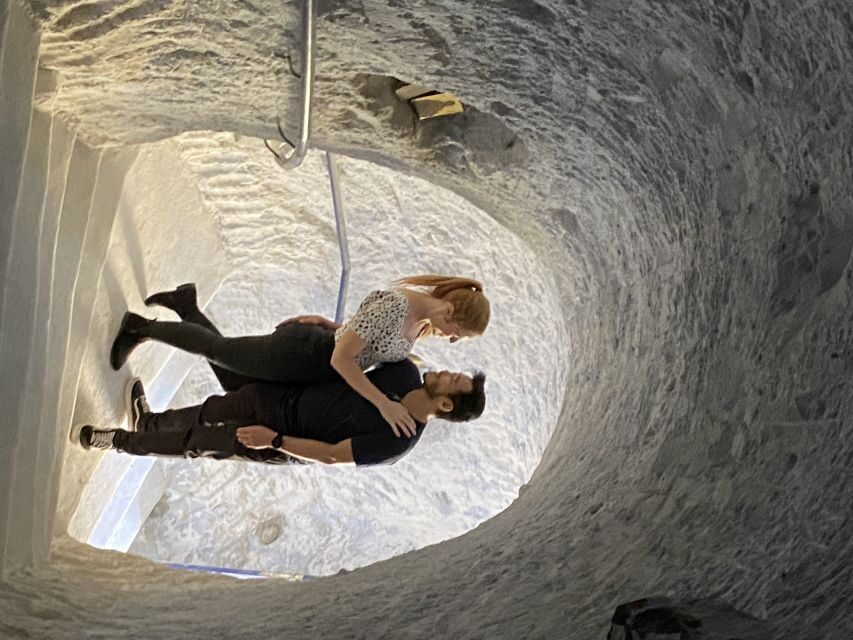 Santorini: Wine Tasting and Cave Settlement Tour - Cave settlement time: cobblestones, Blue dome photos, and cave-house glimpses